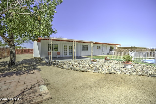 3061 W Avenida Cresta, Tucson, AZ 85745 - back of property featuring french doors, board and batten siding, and a patio area
