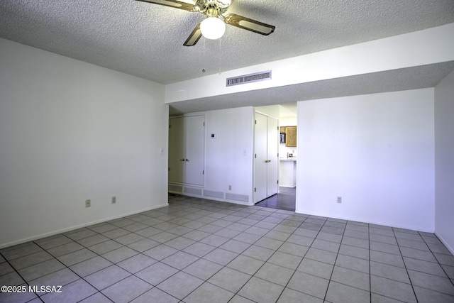 3061 W Avenida Cresta, Tucson, AZ 85745 - unfurnished room with a textured ceiling, a ceiling fan, light tile patterned floors, and baseboards