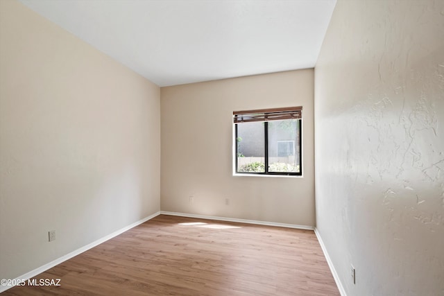 11460 N Palmetto Dunes Ave, Tucson, AZ 85737 - spare room featuring light wood-type flooring and baseboards