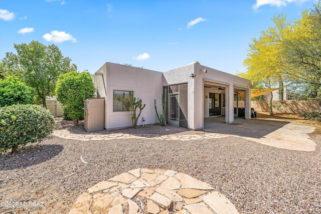 11460 N Palmetto Dunes Ave, Tucson, AZ 85737 - back of property with stucco siding, fence, a ceiling fan, and a patio