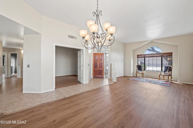 11460 N Palmetto Dunes Ave, Tucson, AZ 85737 - unfurnished dining area with light wood-type flooring, baseboards, visible vents, and a notable chandelier