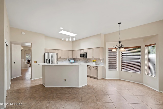 11460 N Palmetto Dunes Ave, Tucson, AZ 85737 - kitchen with light tile patterned floors, an inviting chandelier, light countertops, backsplash, and appliances with stainless steel finishes