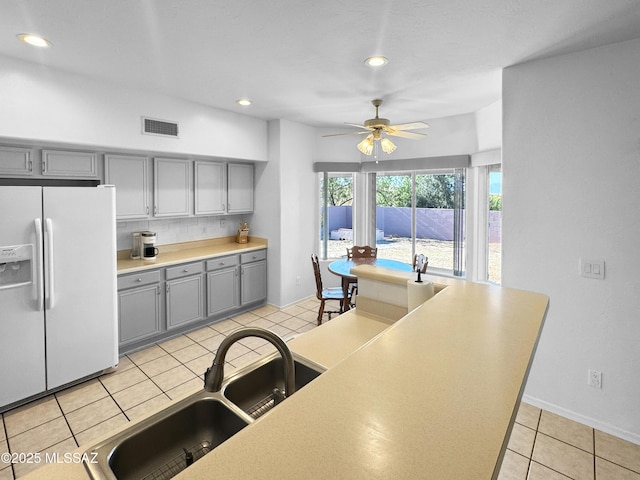 3021 E Dellwood Pl, Vail, AZ 85641 - kitchen featuring ceiling fan, a sink, white fridge with ice dispenser, gray cabinetry, and visible vents