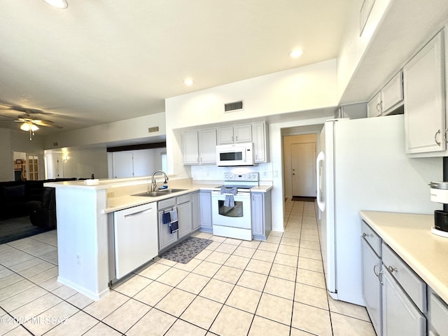 3021 E Dellwood Pl, Vail, AZ 85641 - kitchen with visible vents, a sink, light tile patterned floors, and white appliances