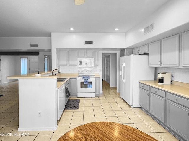 3021 E Dellwood Pl, Vail, AZ 85641 - kitchen with white appliances, gray cabinetry, light tile patterned floors, and visible vents