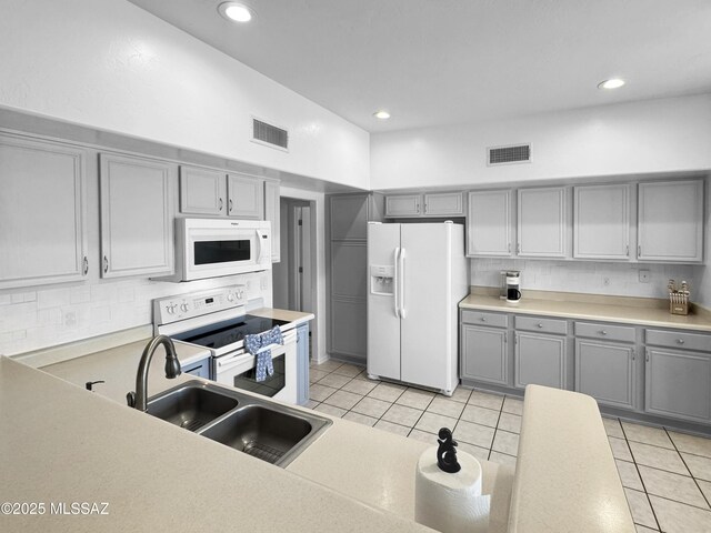 3021 E Dellwood Pl, Vail, AZ 85641 - kitchen with visible vents, a sink, gray cabinets, and white appliances