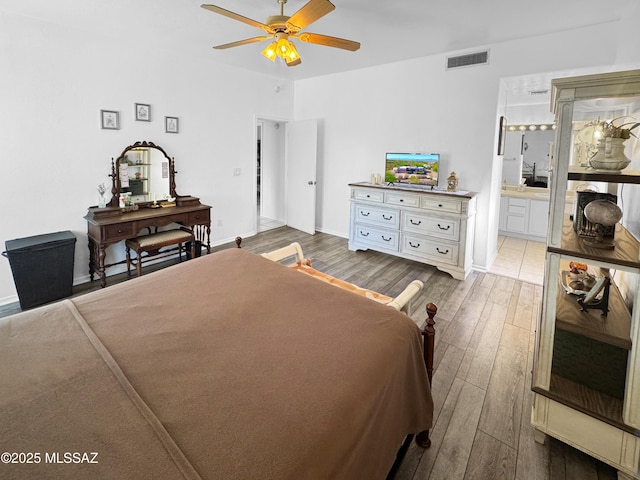 3021 E Dellwood Pl, Vail, AZ 85641 - bedroom with visible vents, wood finished floors, baseboards, ceiling fan, and ensuite bath