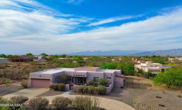 3021 E Dellwood Pl, Vail, AZ 85641 - southwest-style home featuring concrete driveway, fence, a mountain view, and stucco siding