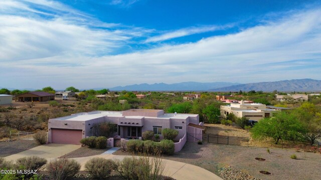 3021 E Dellwood Pl, Vail, AZ 85641 - view of front of home with fence, stucco siding, concrete driveway, an attached garage, and a mountain view