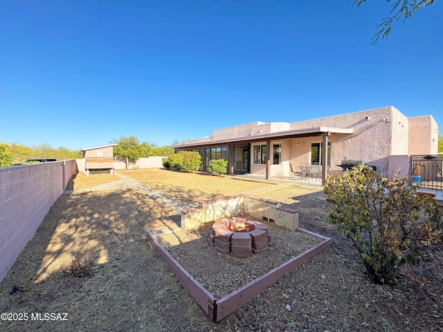 3021 E Dellwood Pl, Vail, AZ 85641 - back of house with stucco siding, a fenced backyard, a patio area, and an outdoor fire pit