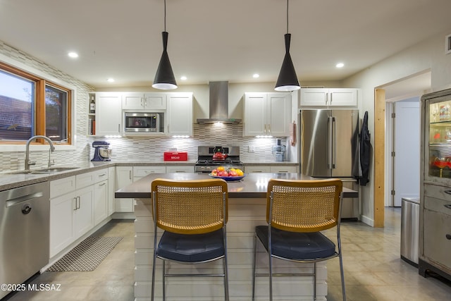 1321 N Norris Ave, Tucson, AZ 85719 - kitchen featuring wall chimney range hood, appliances with stainless steel finishes, a sink, decorative backsplash, and white cabinets
