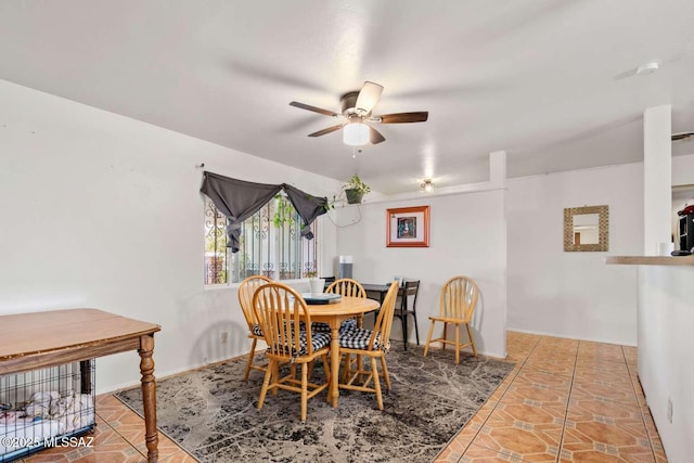 dining room featuring tile patterned flooring, baseboards, and ceiling fan