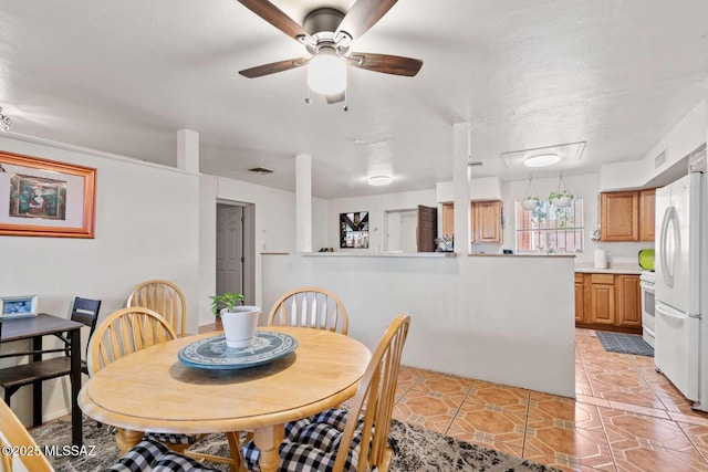 dining area with visible vents, ceiling fan, and light tile patterned floors