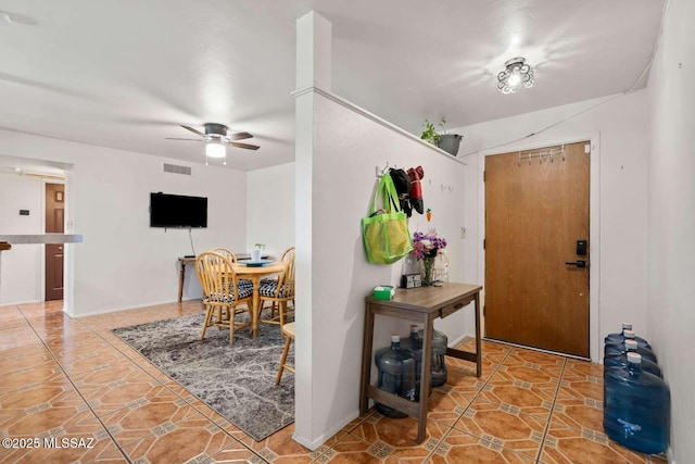 tiled foyer entrance with visible vents and ceiling fan