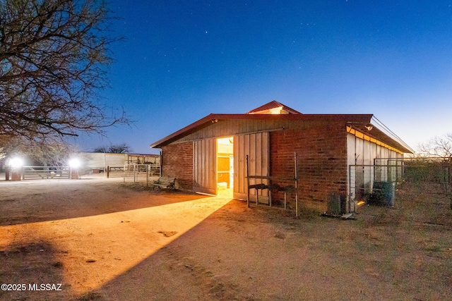 822 E Pomerene Rd, Benson, AZ 85602 - view of side of home with brick siding, board and batten siding, fence, and central air condition unit