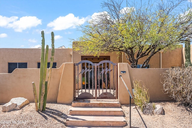 view of gate with a fenced front yard
