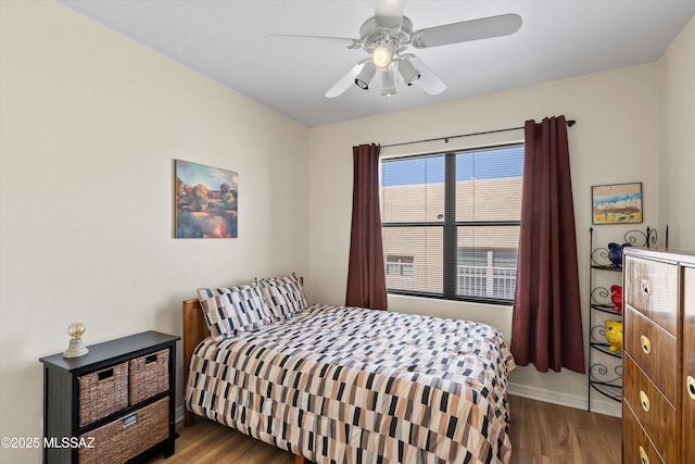 bedroom featuring wood finished floors, ceiling fan, and baseboards
