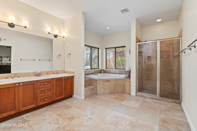 full bathroom featuring a sink, a bath, double vanity, and a stall shower