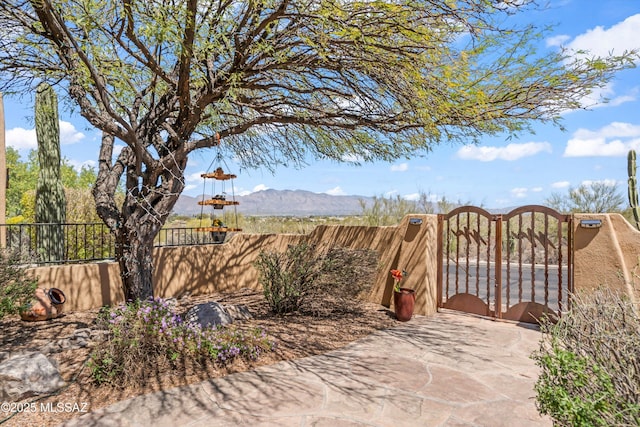 exterior space featuring a mountain view and fence