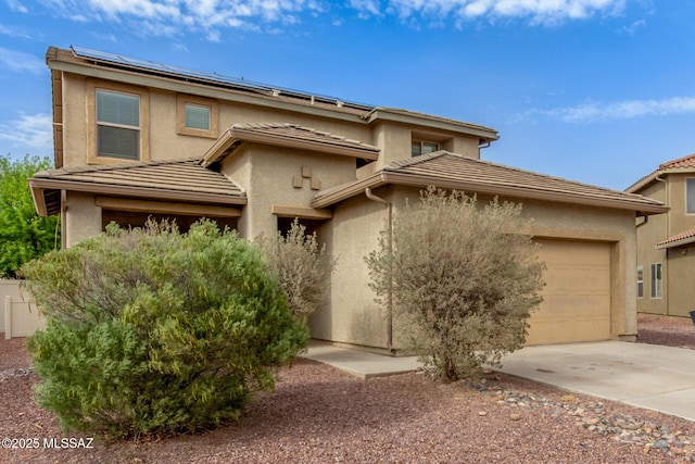 20950 E Frontier Rd, Red Rock, AZ 85145 - view of front facade featuring concrete driveway, solar panels, stucco siding, and a garage