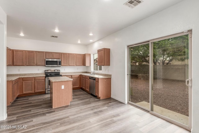 20950 E Frontier Rd, Red Rock, AZ 85145 - kitchen featuring appliances with stainless steel finishes, wood finished floors, plenty of natural light, recessed lighting, and a sink