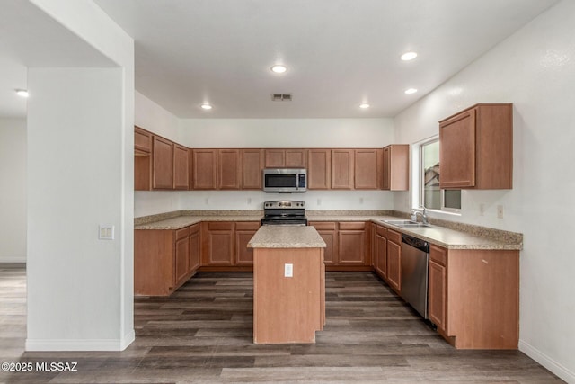 20950 E Frontier Rd, Red Rock, AZ 85145 - kitchen with appliances with stainless steel finishes, a sink, baseboards, a center island, and dark wood-type flooring