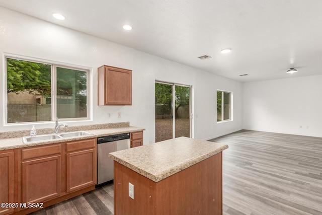20950 E Frontier Rd, Red Rock, AZ 85145 - kitchen with a sink, stainless steel dishwasher, wood finished floors, a kitchen island, and light countertops
