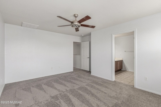 20950 E Frontier Rd, Red Rock, AZ 85145 - unfurnished bedroom with light carpet, ensuite bath, baseboards, and a ceiling fan
