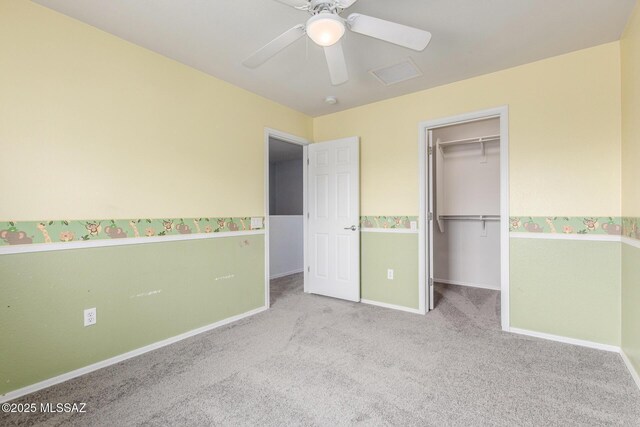 20950 E Frontier Rd, Red Rock, AZ 85145 - unfurnished bedroom with carpet flooring, a walk in closet, baseboards, and a ceiling fan