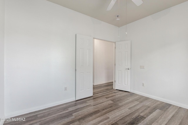20950 E Frontier Rd, Red Rock, AZ 85145 - unfurnished bedroom featuring wood finished floors, baseboards, and ceiling fan