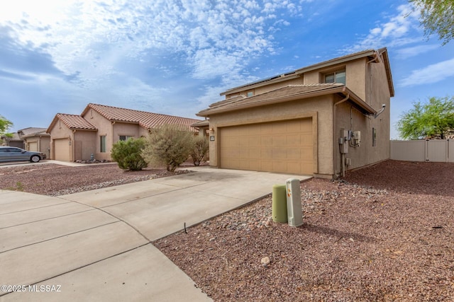 20950 E Frontier Rd, Red Rock, AZ 85145 - view of front facade featuring concrete driveway, fence, and stucco siding