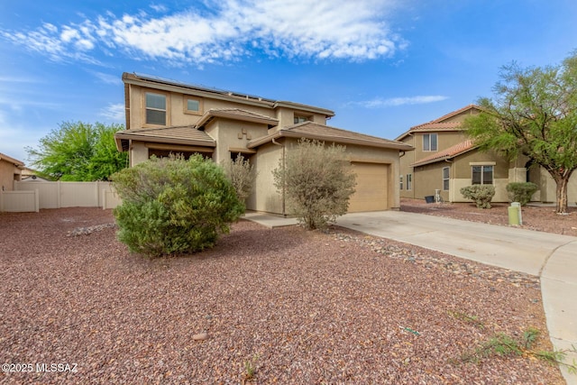 20950 E Frontier Rd, Red Rock, AZ 85145 - view of front of property featuring concrete driveway, solar panels, an attached garage, stucco siding, and fence