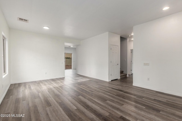 20950 E Frontier Rd, Red Rock, AZ 85145 - unfurnished living room featuring dark wood-type flooring, baseboards, and recessed lighting