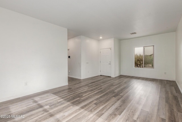 20950 E Frontier Rd, Red Rock, AZ 85145 - empty room featuring wood finished floors, recessed lighting, and baseboards