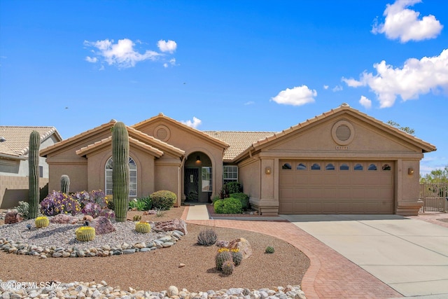 65749 E Mesa Ridge Ct, Tucson, AZ 85739 - view of front of house with driveway, a garage, stucco siding, and a tile roof