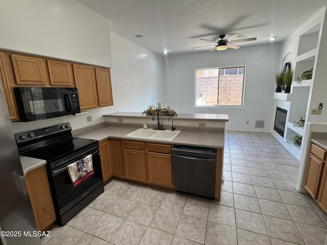 7456 E Placita Del Espiritu, Tucson, AZ 85715 - kitchen with black appliances, a sink, a peninsula, and brown cabinetry