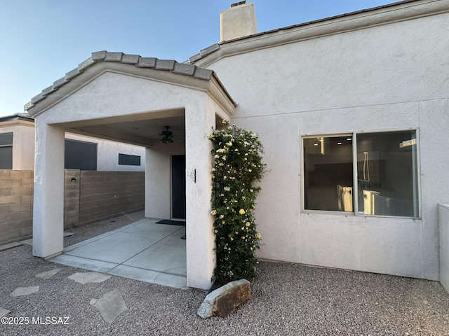 7456 E Placita Del Espiritu, Tucson, AZ 85715 - view of property exterior with a patio area, stucco siding, and ceiling fan