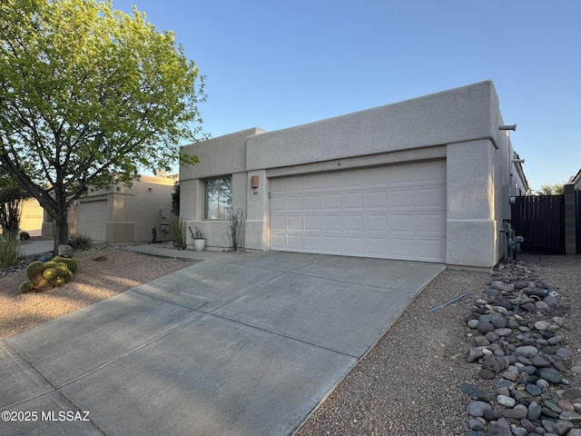 7456 E Placita Del Espiritu, Tucson, AZ 85715 - pueblo-style house featuring stucco siding, concrete driveway, and a garage
