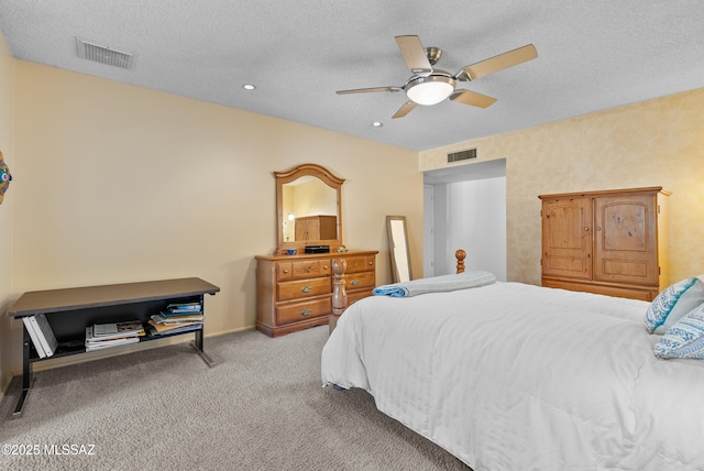 carpeted bedroom with visible vents, a ceiling fan, recessed lighting, and a textured ceiling