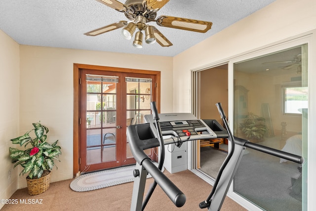 exercise area with french doors, a ceiling fan, carpet floors, and a textured ceiling