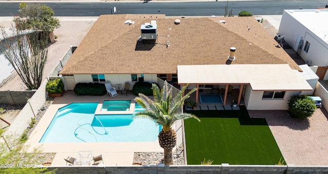 view of pool with a fenced backyard, a pool with connected hot tub, and a patio