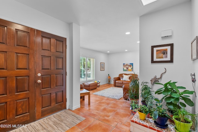 foyer entrance with recessed lighting, baseboards, and light tile patterned flooring