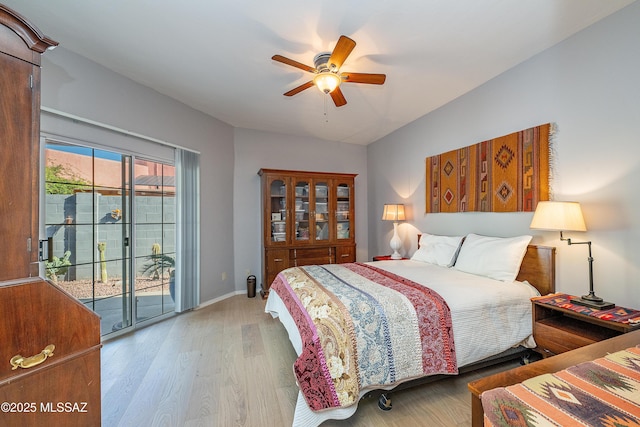 bedroom with baseboards, access to outside, wood finished floors, and a ceiling fan