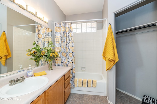 bathroom featuring shower / tub combo, baseboards, and vanity
