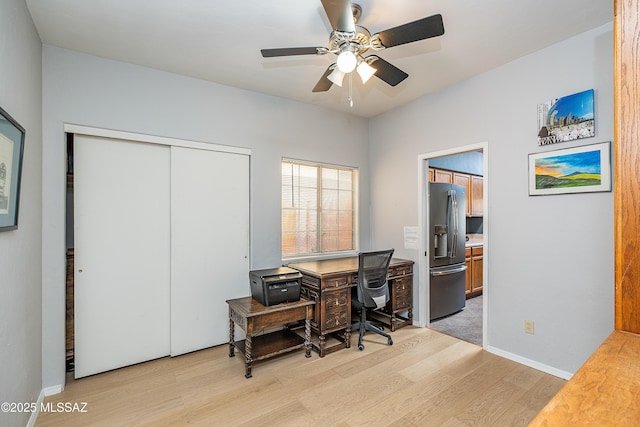 office featuring light wood-type flooring and a ceiling fan