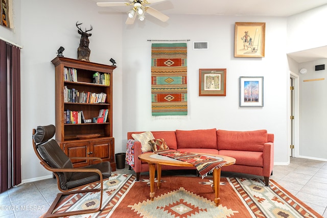 living area with a ceiling fan, baseboards, tile patterned flooring, and visible vents