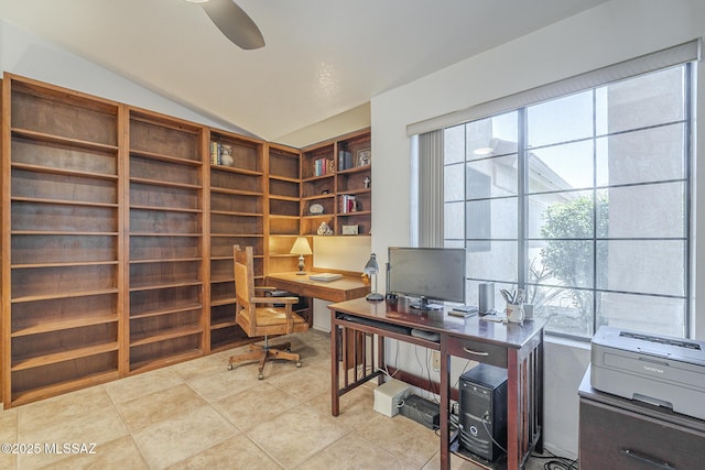 tiled office space featuring built in shelves and vaulted ceiling