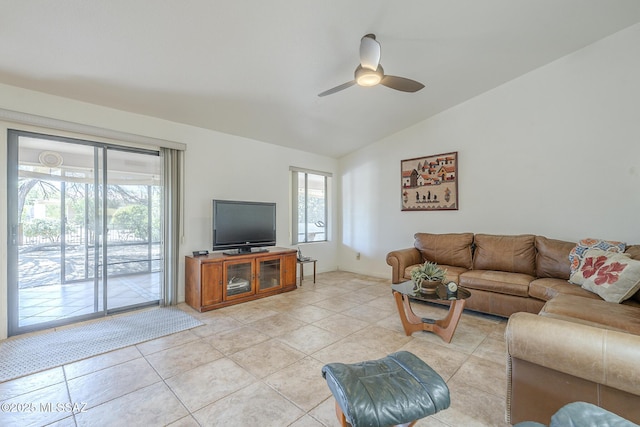 living area featuring lofted ceiling, a ceiling fan, and light tile patterned floors