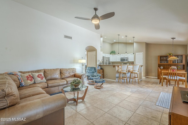 living room featuring arched walkways, light tile patterned flooring, visible vents, recessed lighting, and ceiling fan