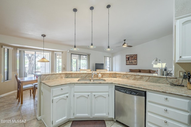 kitchen with light stone counters, a ceiling fan, stainless steel dishwasher, a sink, and white cabinetry